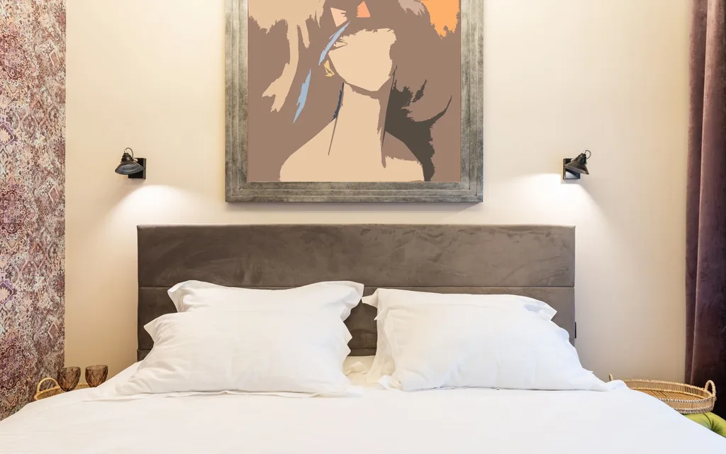 Made bed with pillows against a headboard